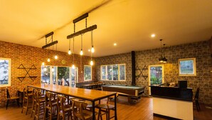 A spacious indoor area with a pool table, wooden bar counter, and multiple seating arrangements. - Batuque Town Villa 2 (Batu)