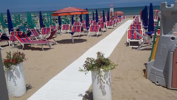 Playa privada, playa de arena blanca, camastros y sombrillas