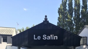 A building with a sign reading "Le Salon" at the entrance. - Le Salin (Brehal)