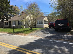 A residential street with houses, a mailbox, and a parked SUV. - Walk to the Beach!!! (Centerville)