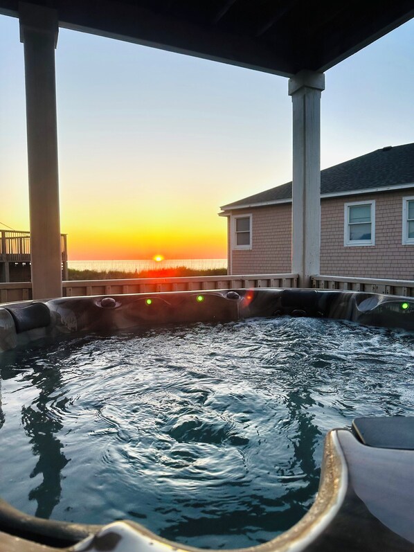A hot tub under a covered area with a sunset view. - 6BR-5Bth Semi-Oceanfront, heated Pool, Elevator. 75 Yards to the beach! Views!! (Rodanthe)