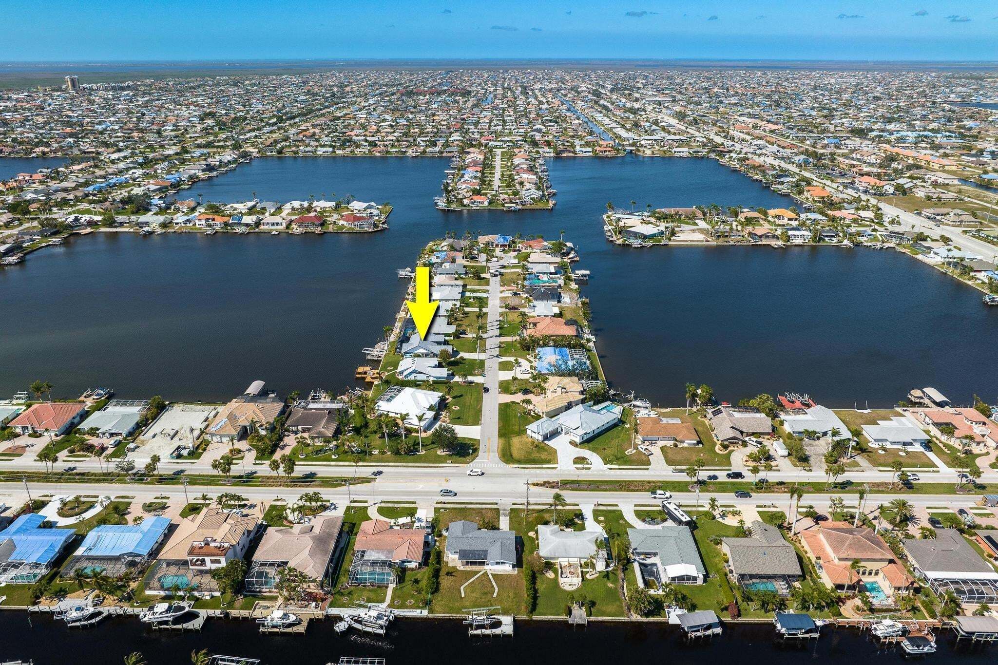 An aerial view of a residential area with water bodies and houses.