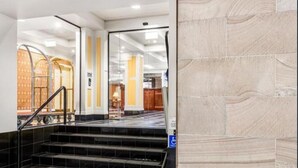 A hotel lobby with a staircase leading to a reception area. - S&P Apartments - Central Station (Brisbane)