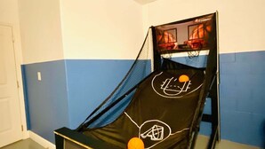 A single bed with a basketball hoop attached to the headboard, a door to the left, and a blue and white wall. - 6BR Solterra Pool Home | Spa, Game Room, BBQ, Themed Rooms & 3 Kings (Davenport)