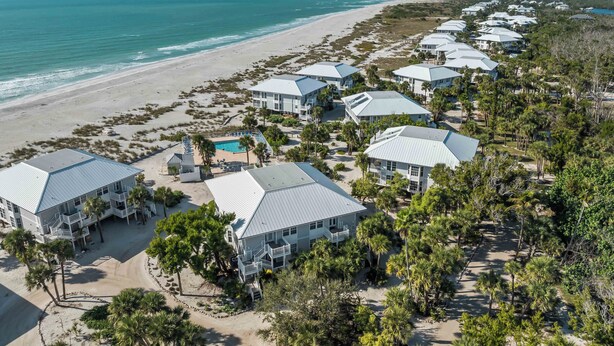 A coastal resort with multiple buildings, a swimming pool, and a beach view. - Stay and Play all Day in this Very Nice Spacious Beach Resort Villa! C1622A (Englewood)