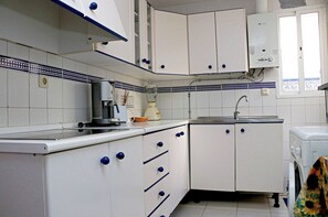 Enjoy cooking in this well-equipped kitchen with an espresso machine, sink, and natural light from the window.