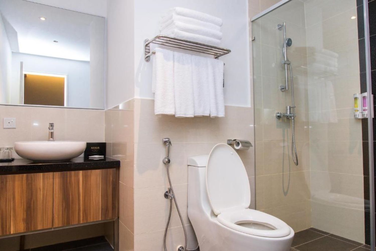 A modern bathroom with a sink, toilet, and shower.
