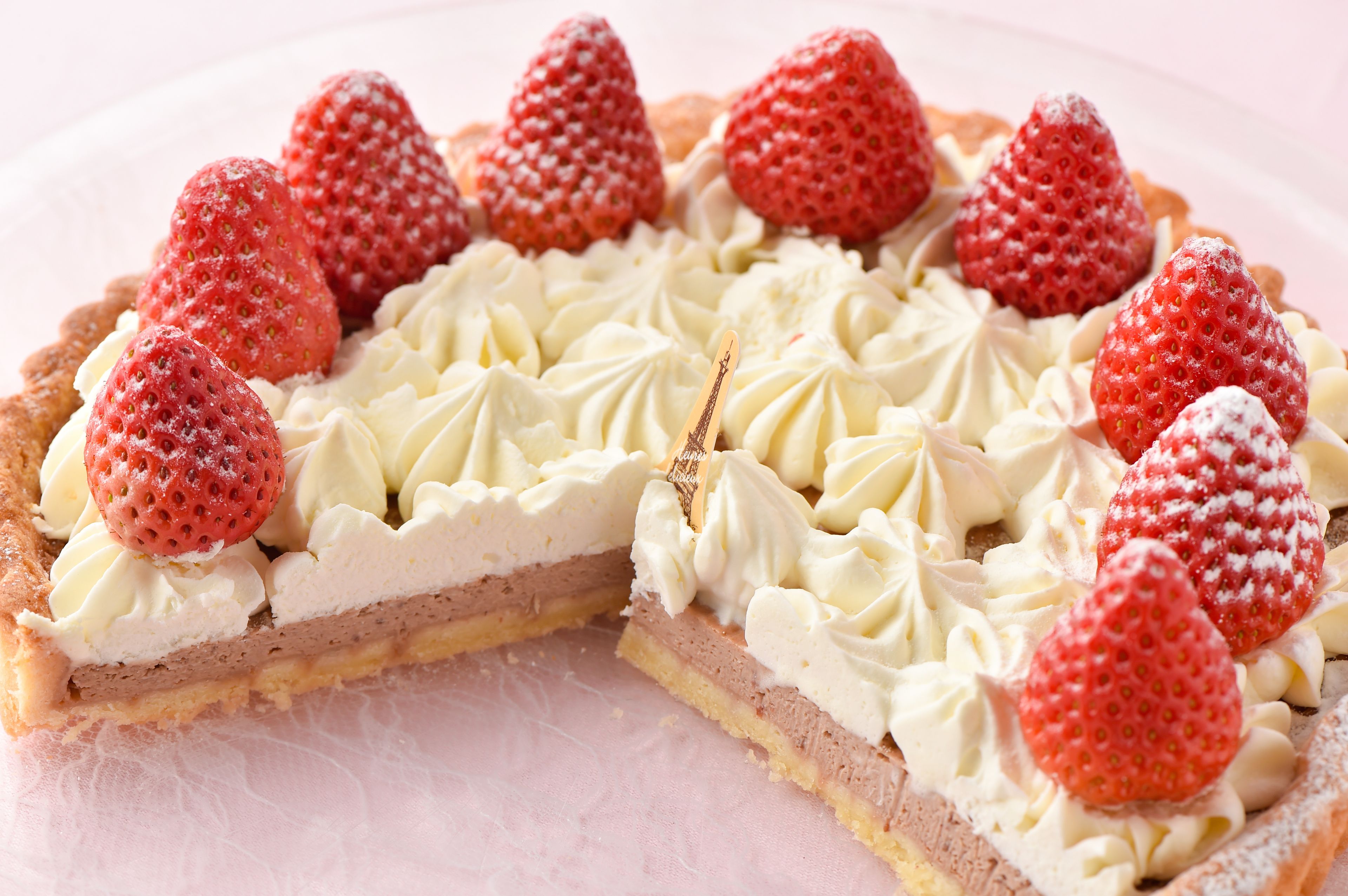 A slice of strawberry shortcake pie with whipped cream and strawberries on top.
