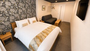 A hotel room with a large bed, a sofa, a bedside table, a wardrobe, and a mirror. - Stay SAKURA Kyoto Nijo Seasons (Kyoto)