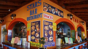 A Stars Bar Restaurant with a counter, menu boards, and seating area. - Stars Hotel - Adults Only (Corfu)