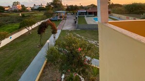 A residential area with a swimming pool, a covered patio, and a well-maintained lawn. - Stars Hotel - Adults Only (Corfu)