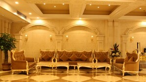 A luxurious lobby with a checkered floor, ornate sofas, and wall sconces. - Zhuhai Rongfeng Hotel (Zhuhai)