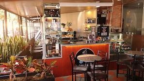 A café with a counter, seating area, and various items on display. - Hotel Dorado Gold Bogota (Bogotá)