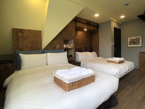 A double room with two beds, wooden headboards, and a sloped ceiling. - Puli story house (Puli)