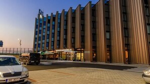 A modern hotel with a vertical facade, large windows, and a visible entrance with signage. - Hotel D1 (Ostrovacice)