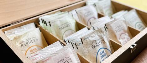 An open wooden box containing multiple packets of 'The Nor Aromatise' tea from Parney's.