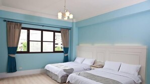 A room with two beds, a window with curtains, a chandelier, and a white headboard. - Mallorca B&B (Taitung)