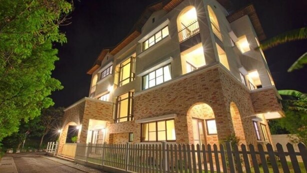 A multi-story building with a brick facade and multiple windows. - Mallorca B&B (Taitung)