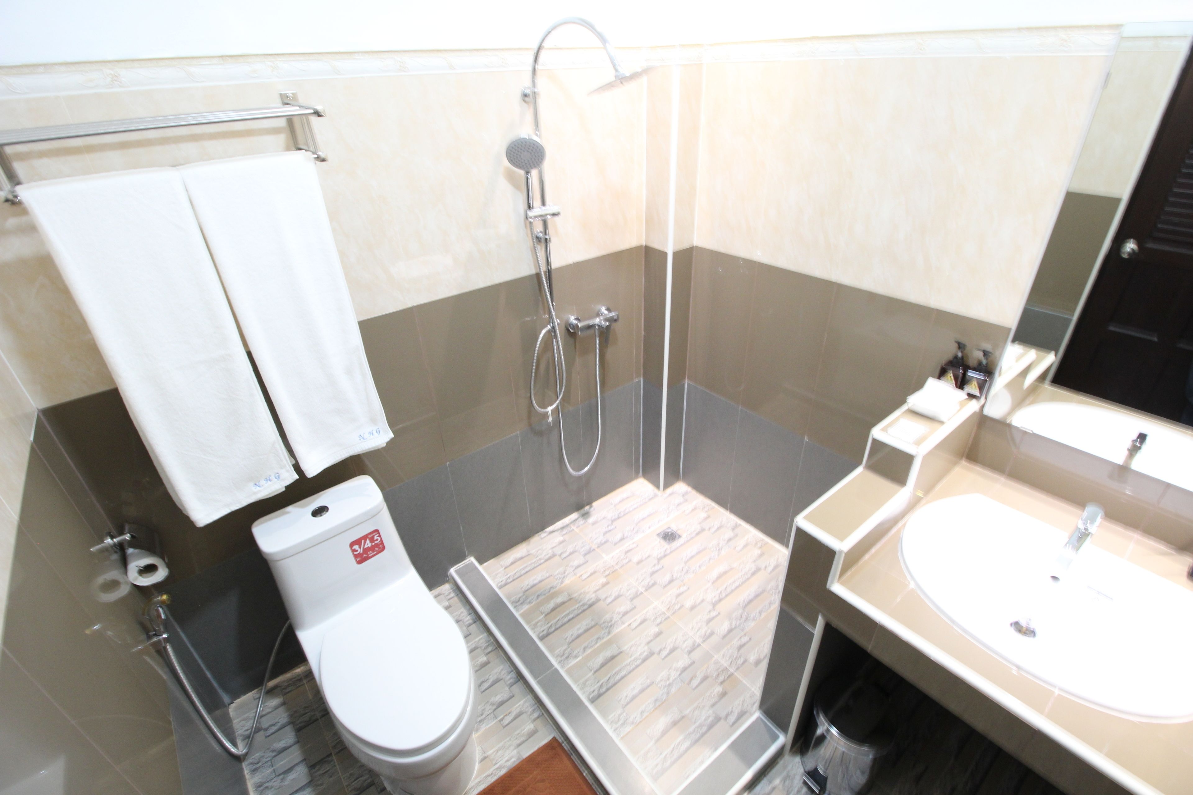 Un baño moderno con ducha, inodoro y lavabo.