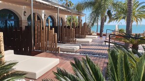 A resort with a pool area, outdoor seating, and a view of the sea. - Miami Mar - Boutique Hotel & Restaurant (Sant Carles de la Rapita)