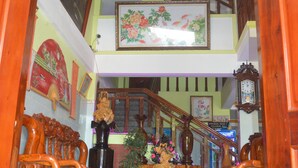A staircase with wooden railings leading to a second floor. - Phong Nha River View Hotel (Phong Nha)