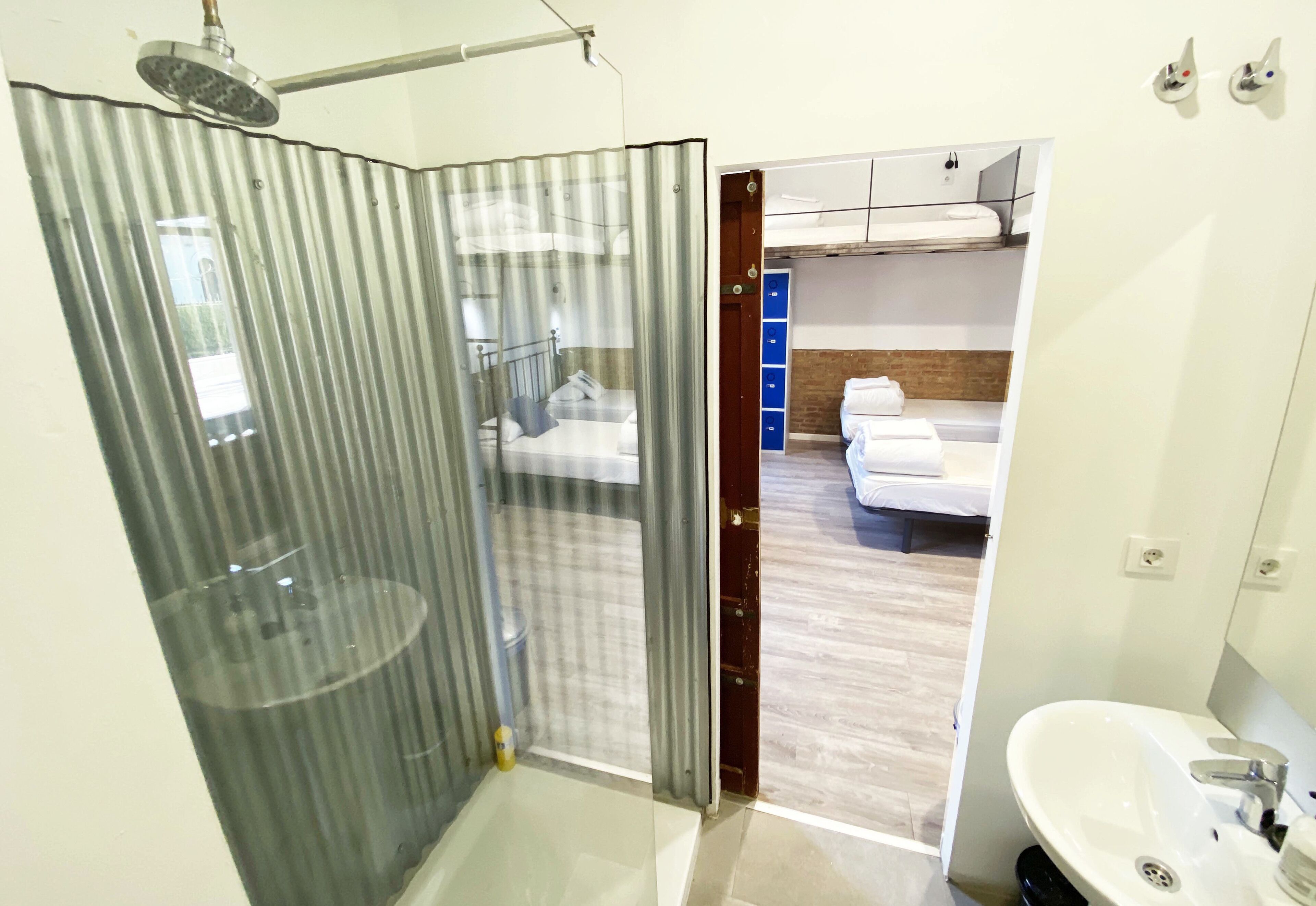 A modern bathroom with a shower, a sink, and a toilet.
