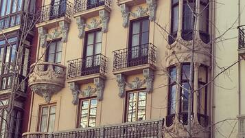 A multi-story building with ornate balconies and large windows.