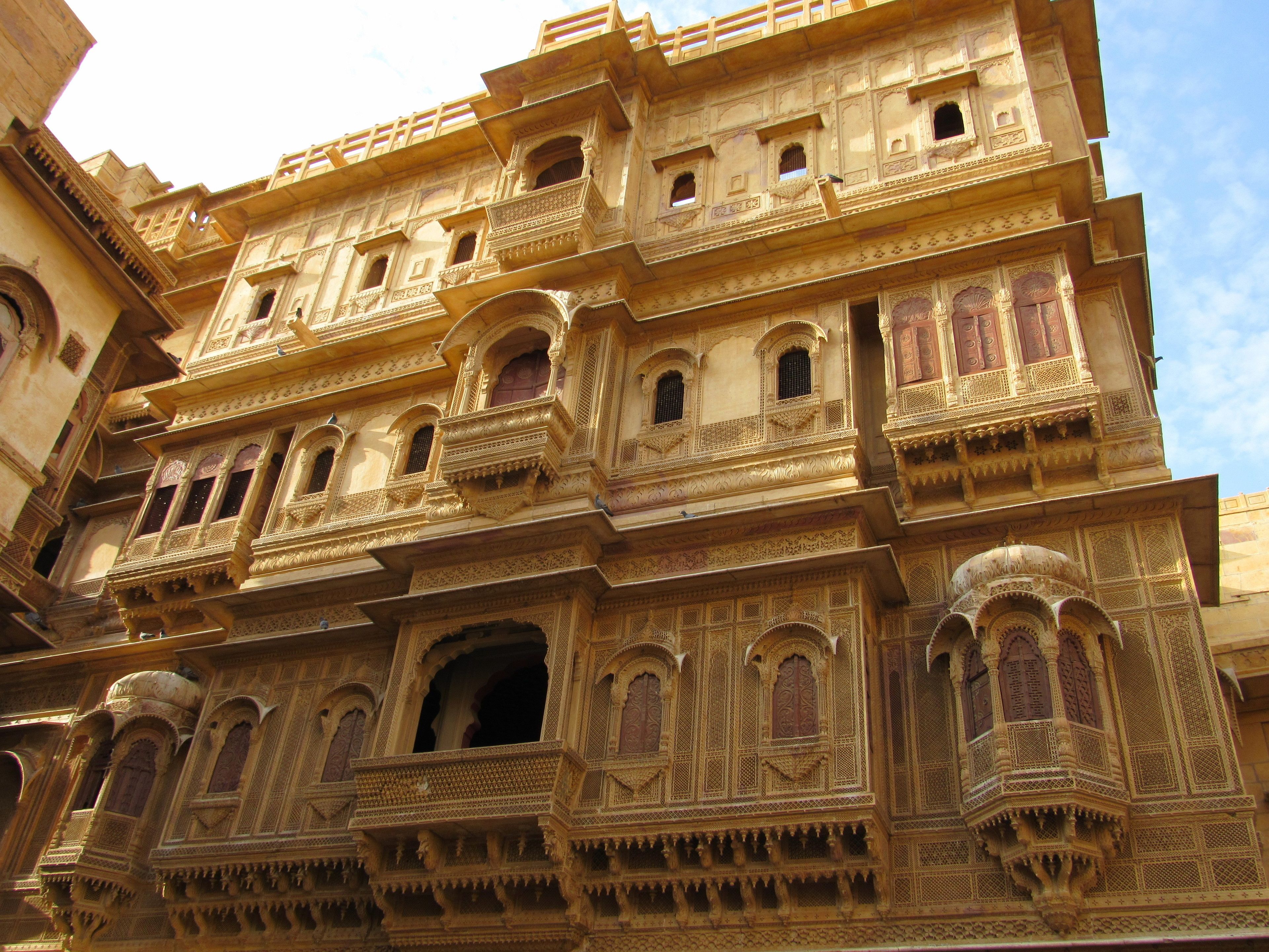 A multi-story building with intricate architectural details, including arched windows and ornate balconies.