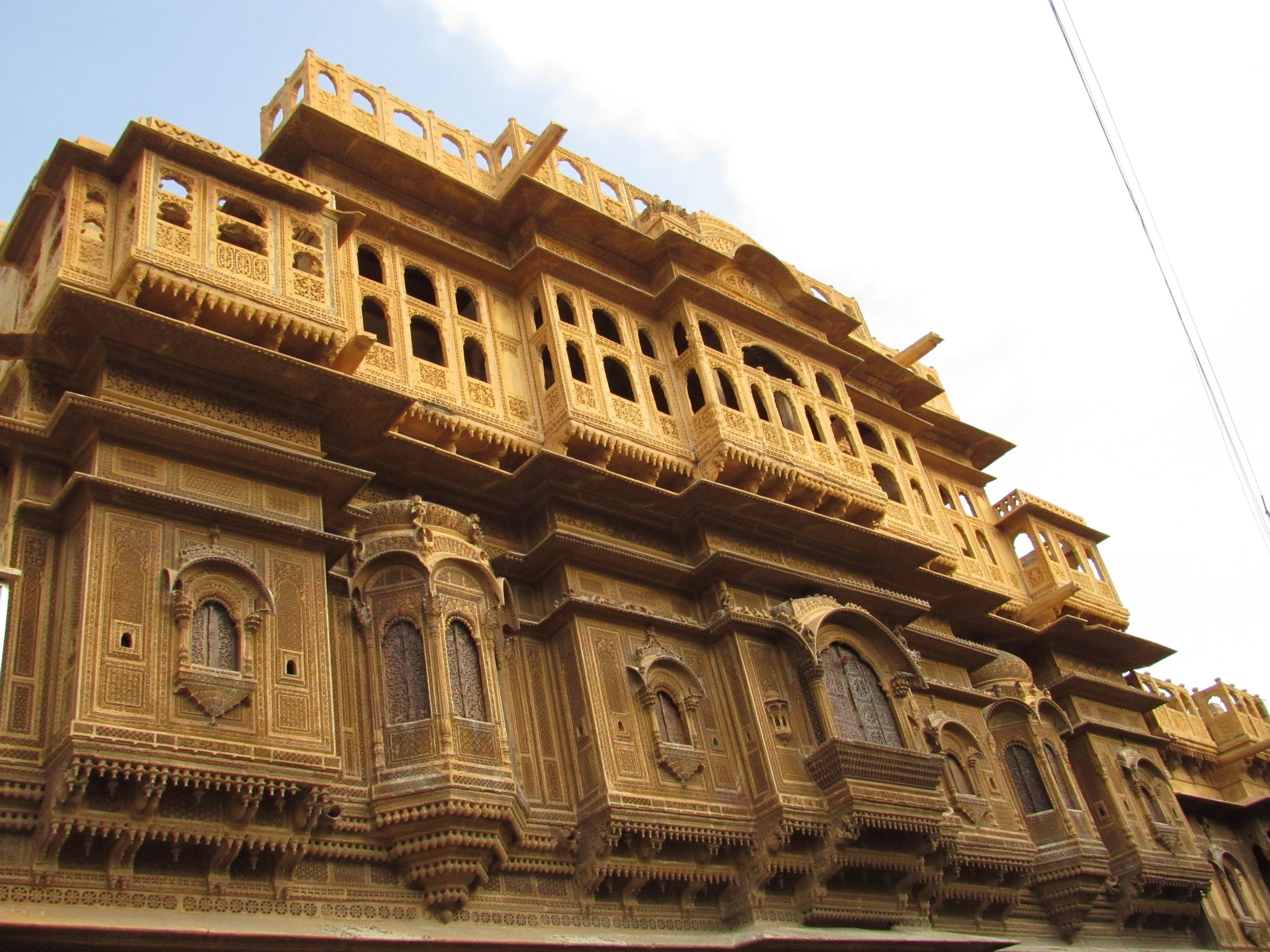A multi-story building with intricate architectural details, including arched windows and ornate balconies.