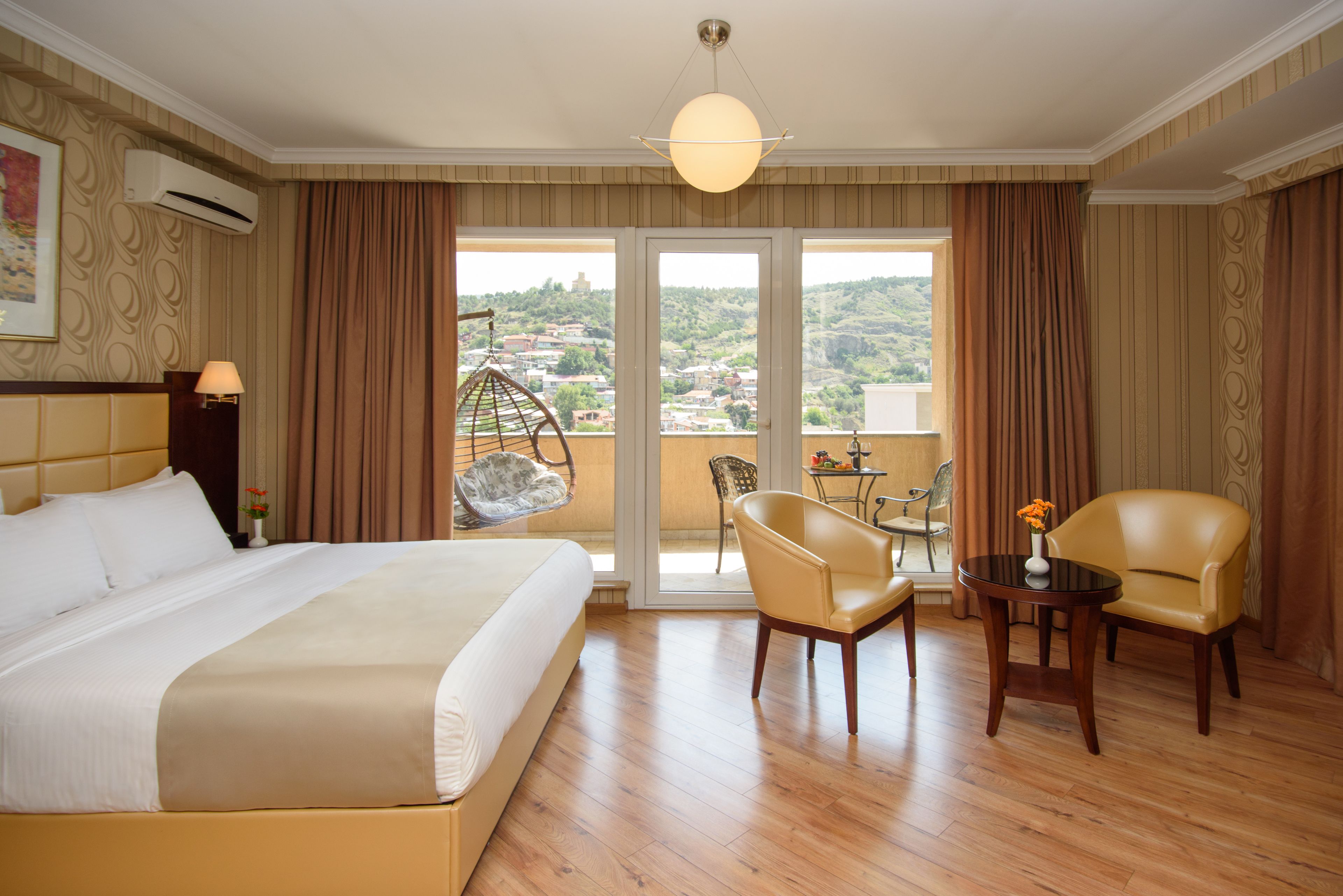 panoramic room, 1 king bed, balcony, city view (a building) | 1 bedroom, minibar, in-room safe, desk