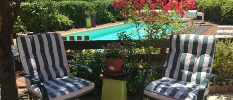 Seasonal outdoor pool, open 3:30 PM to 7:00 PM, pool umbrellas