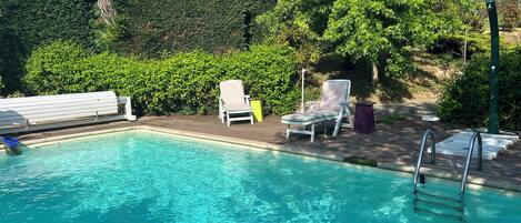 Seasonal outdoor pool, open 3:30 PM to 7:00 PM, pool umbrellas