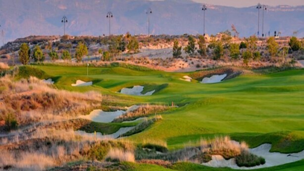 A golf course with sand bunkers and a mountainous backdrop. - Casa Rurales Ventaseca (Mazarron)