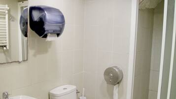 A bathroom with a toilet, sink, and bidet.