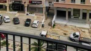 A multi-story residential building with balconies, a ground-level commercial space, and a parking area. - El hana apartments (Kalaat El Andalous)