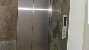 A metallic elevator with a control panel on the wall. - El hana apartments (Kalaat El Andalous)