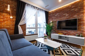 Apartment | Living area | 49-inch flat-screen TV with cable channels, TV - New Wave Apartment Havana (Rzeszów)
