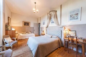 Une chambre avec deux lits, un bureau et une chaise.
