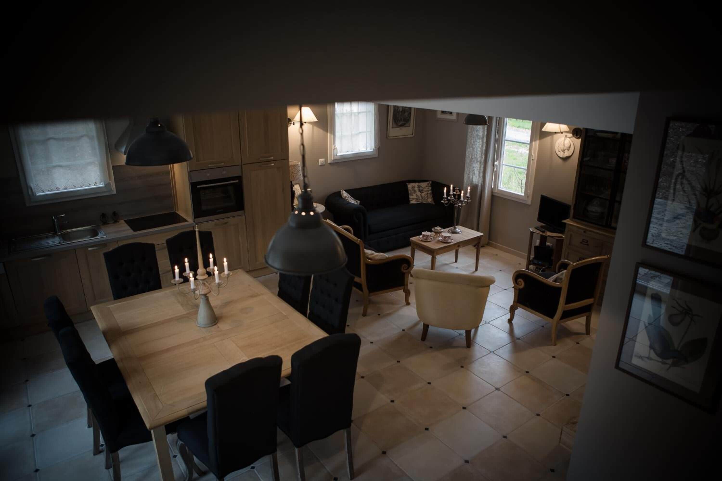 A cozy living space with a dining area, kitchen, and seating area.