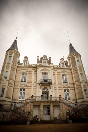 A large, historic building with a symmetrical facade, multiple windows, and two prominent towers. - Chateau de la Moriniere (Beaupreau-en-Mauges)