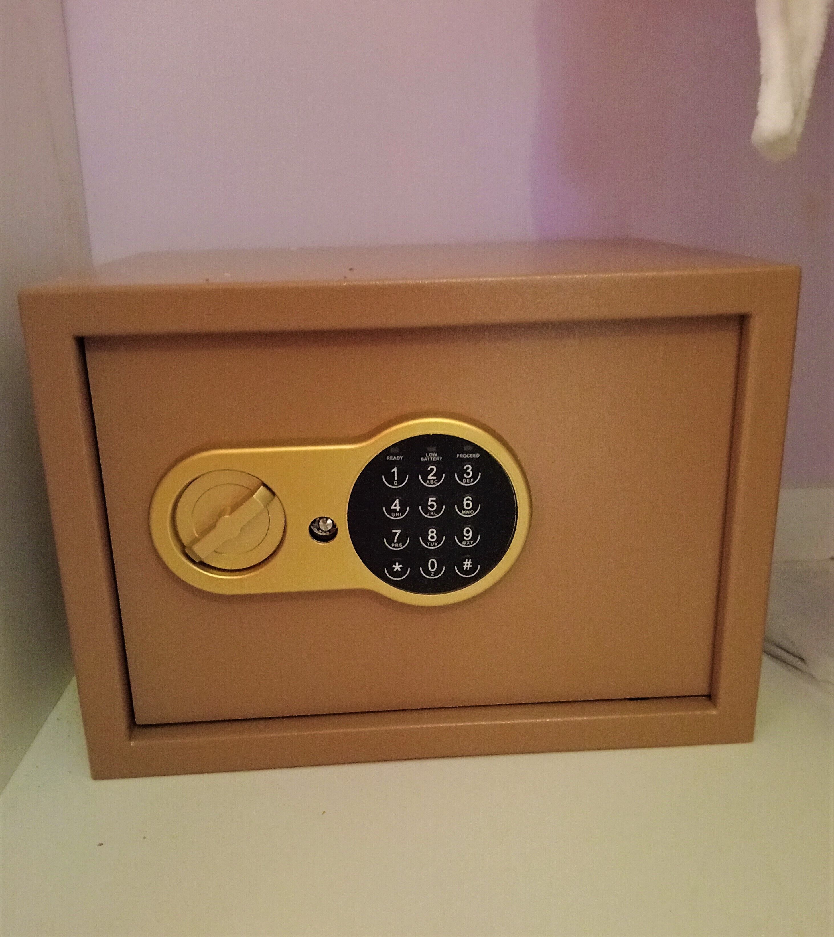 A brown safe with a keypad lock.