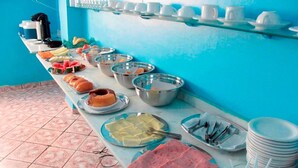 A buffet setup with various food items and utensils. - Grand Center Hotel (Santarém)