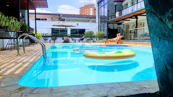 Outdoor pool, open 10 AM to 10 PM, pool umbrellas, pool loungers