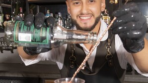 A bartender pouring a drink into a copper mug. - Medellín Vibes (Medellín)
