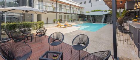 Outdoor pool, open 10 AM to 10 PM, pool umbrellas, pool loungers
