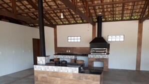 A spacious kitchen with a central island, a built-in oven, and a chimney.
