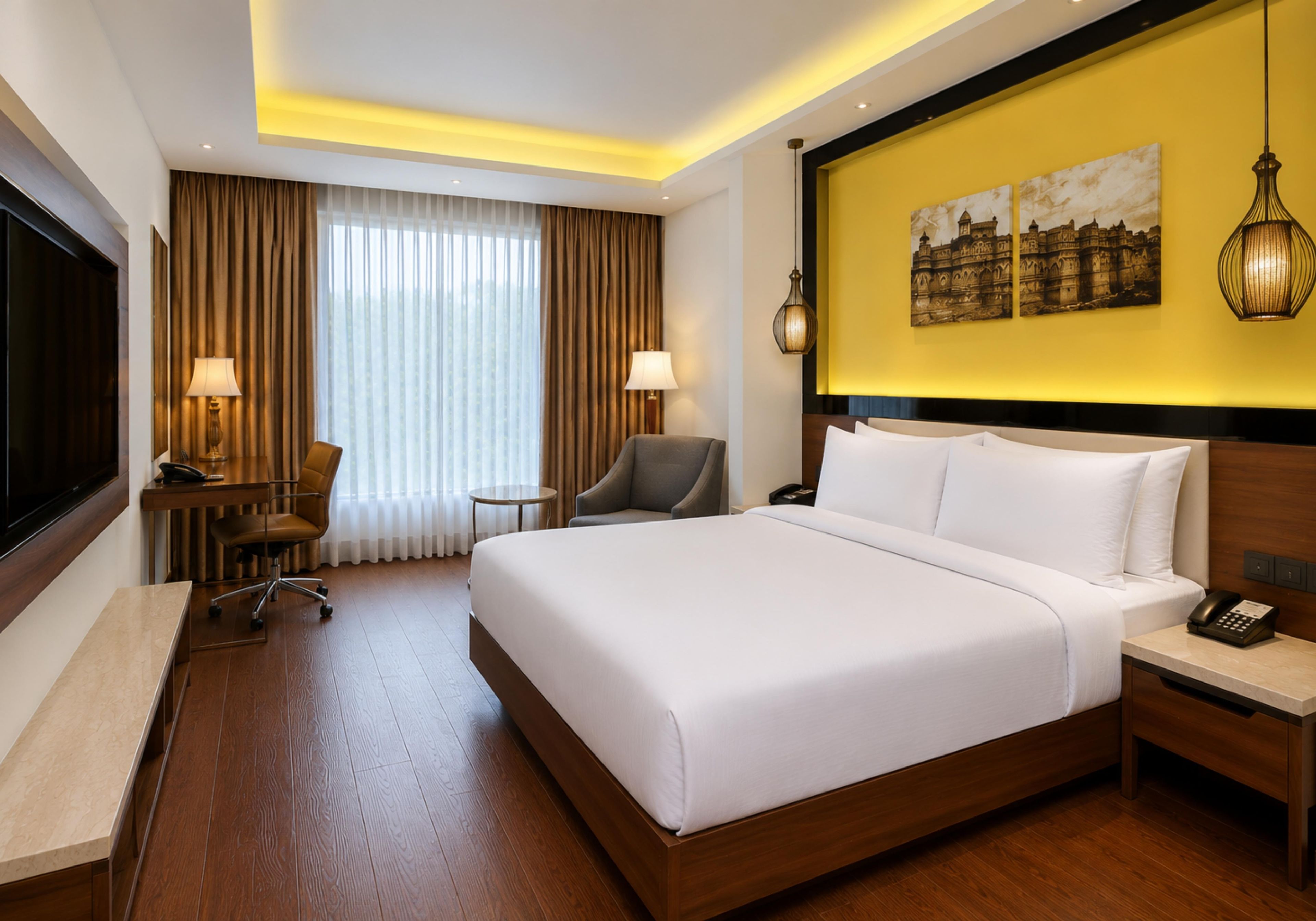 A hotel room with a large bed, a desk, a chair, a TV, and a painting on the wall.