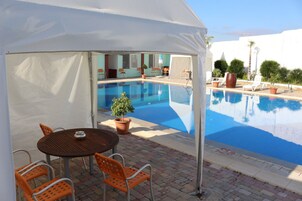 Outdoor pool, open 8 AM to 6 PM, pool umbrellas, pool loungers