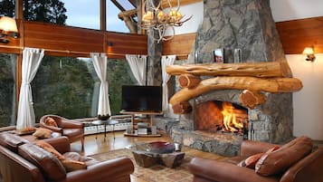 Deluxe Chalet, 5 Bedrooms, Mountain View | Living area | 55-inch LED TV with satellite channels, TV, fireplace