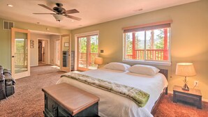 A bedroom with a bed, a ceiling fan, a window with a view, and a bench. - < 1 Mi to Brian Head Resort: Mtn-View Gem w/ Deck (Brian Head)